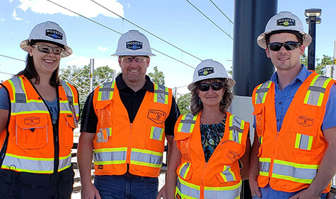 Four workers smiling for the camera.